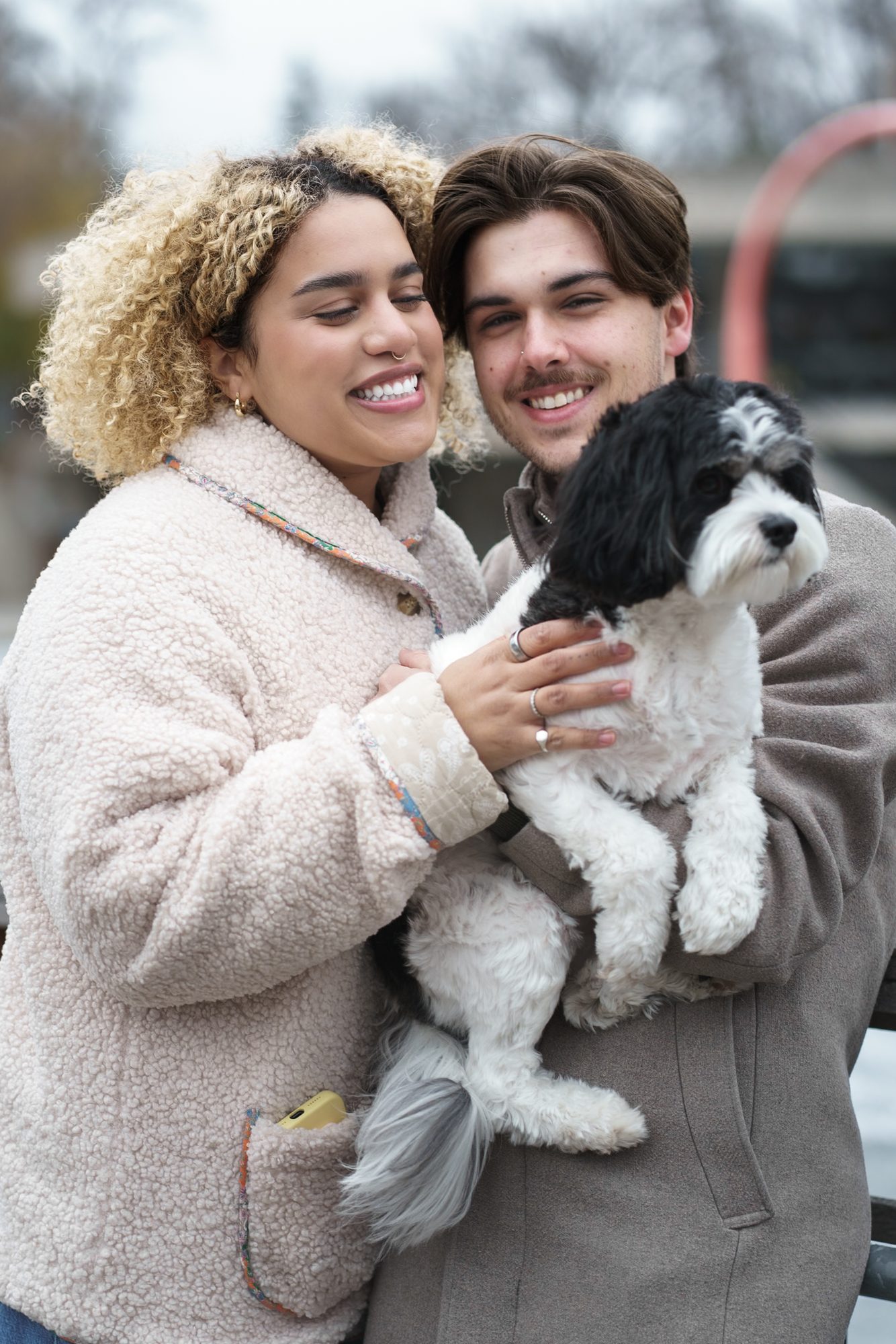 Couple holding their small dog during a Winnipeg engagement session