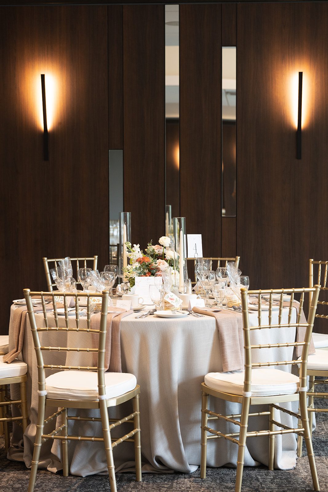 Reception table under warm wall lighting in the Breezy Bend Country Club clubhouse