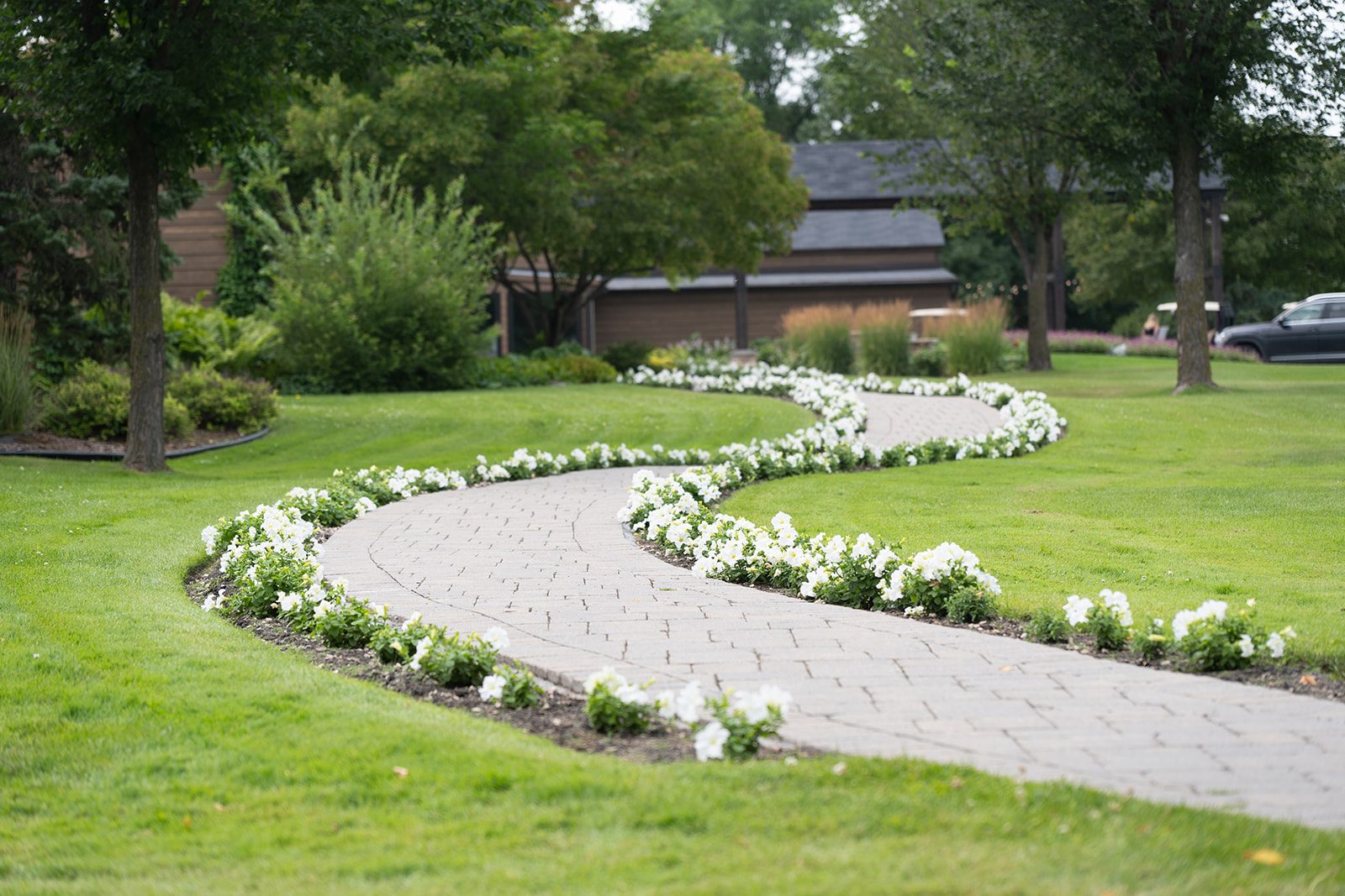 Flower-lined walking path across the grounds at Breezy Bend Country Club, Headingley, Manitoba